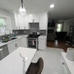 kitchen remodel with white cabinets and gray subway tiles