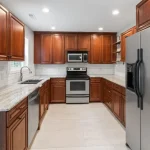 cherry cabinets and white flooring